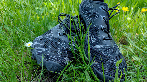 Die Barfußschuhe im Gras, nach der ersten Wanderung auf Schotter